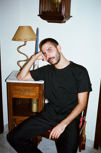 shop Nata studio menswear black t-shirt loose cut wide cut plain front and white outline illustration on back of t-shirt print on back of t-shirt Beirut local production emerging designer Beirut madrid